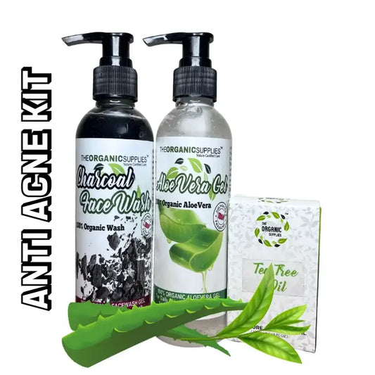 Image of a anti acne combo, three products a pump bottle of charcoal face wash, pump bottle of aloe vera gel for easy application and glass bottle of tea tree oil along with its Packinging box, surrounded with fresh aeo vera and tea tree leaves in white background.    